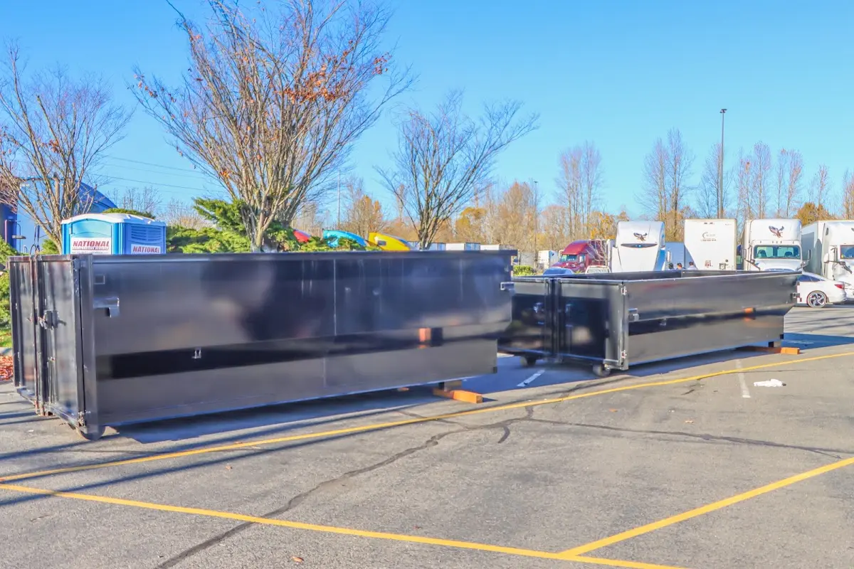 Professional dumpster rental service with roll-off container on residential driveway in Mentor